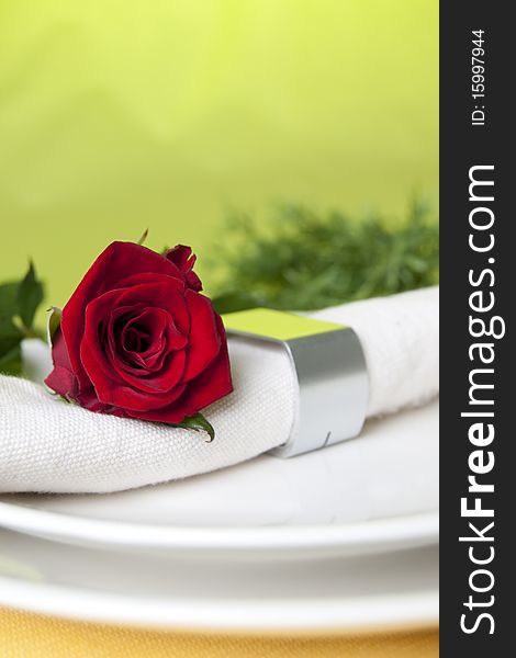 Red rose and white napkin. Red rose and white napkin