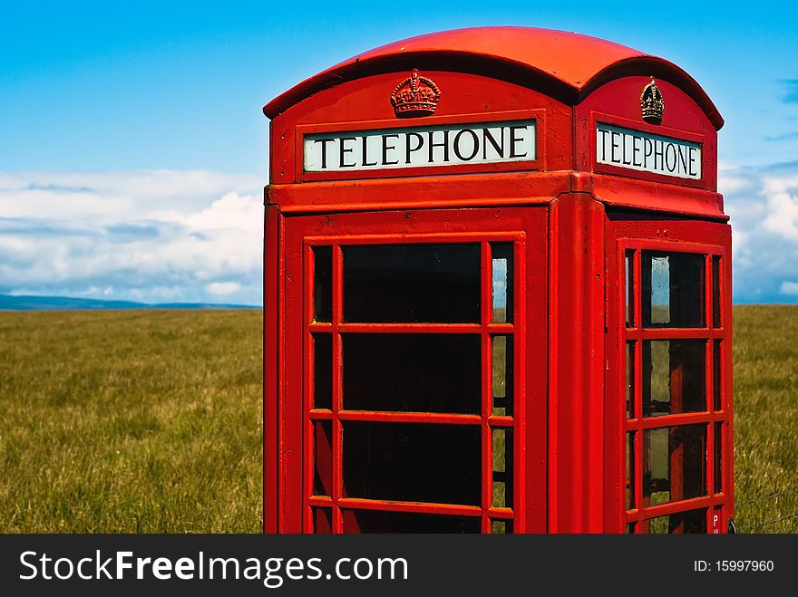 Red phone booth standing alone in landscape. Red phone booth standing alone in landscape