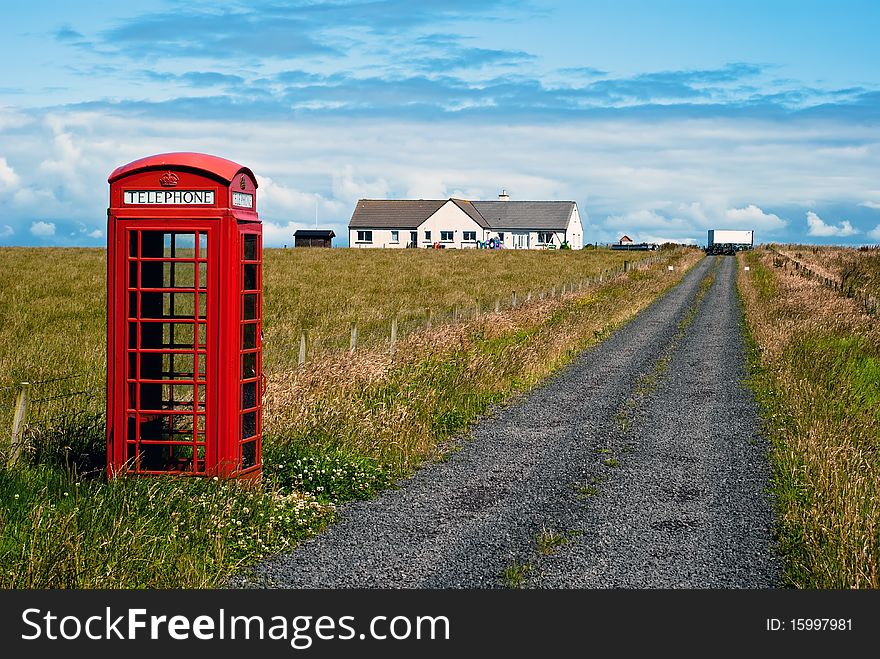 Red phone booth standing alone in landscape. Red phone booth standing alone in landscape