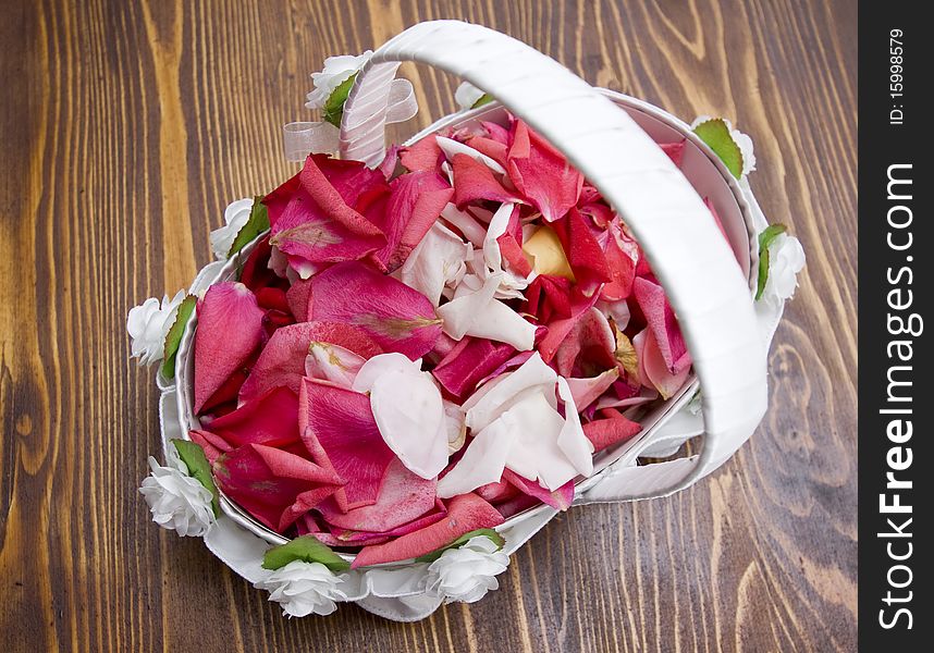 White basket with red rose petals