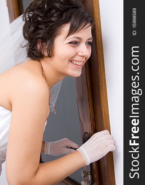 Bride waiting for her fiancee at door