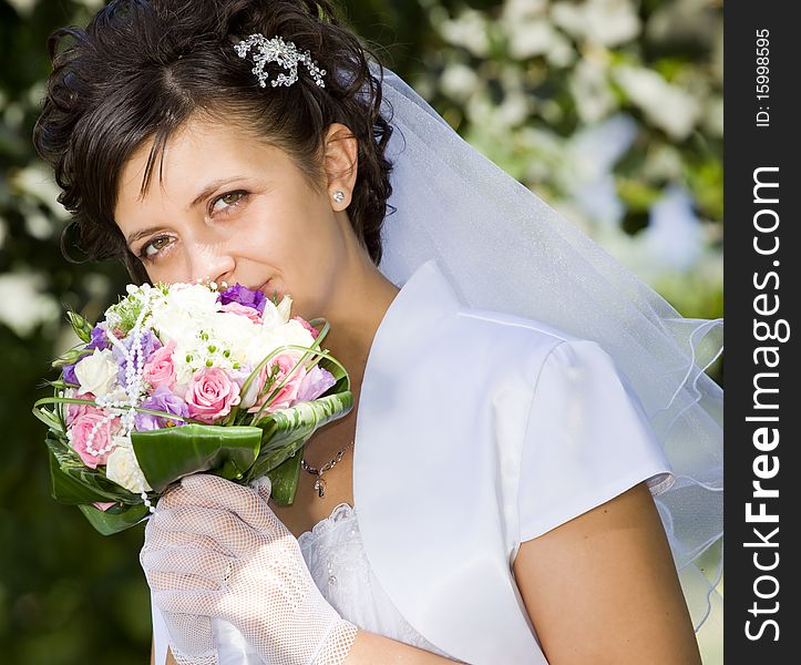 Portrait of the beautiful bride with a bouquet