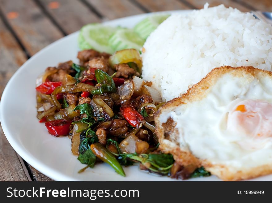 Rice topped with stir-fried pork and basil with fried egg. Rice topped with stir-fried pork and basil with fried egg