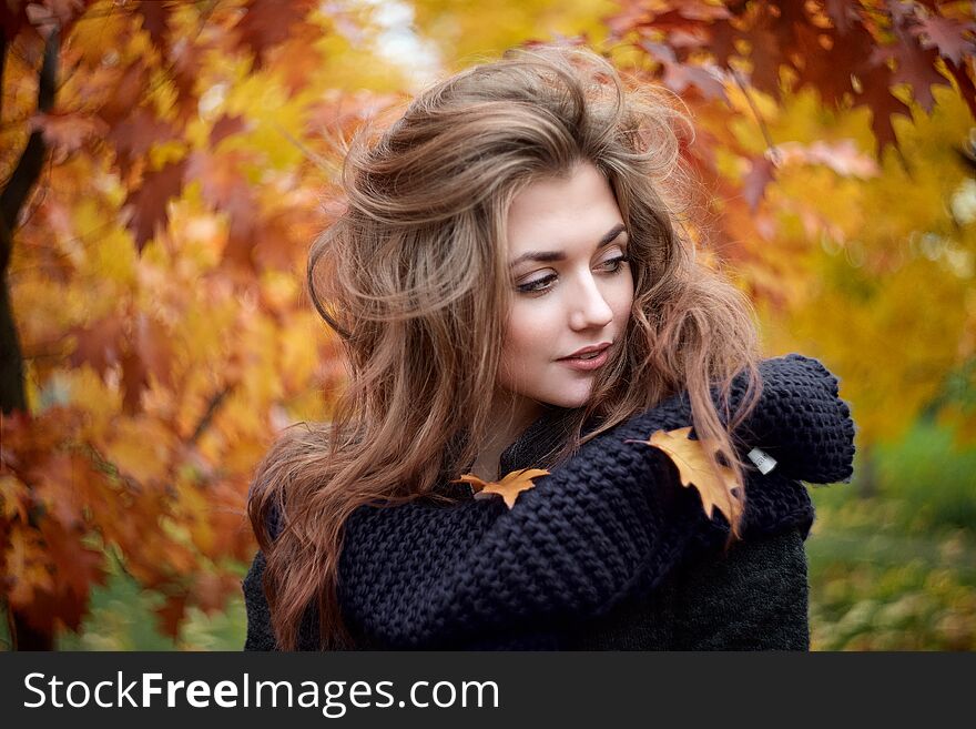 Outdoors portrait of young beautiful woman in scarf