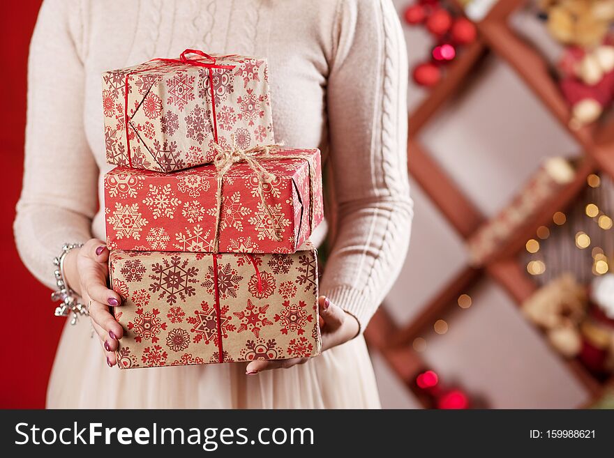 Woman`s  Hands Holding Gift Boxes. Christmas, New Year, Birthday Concept. Festive Background With Bokeh And Sunlight. Magic Fair