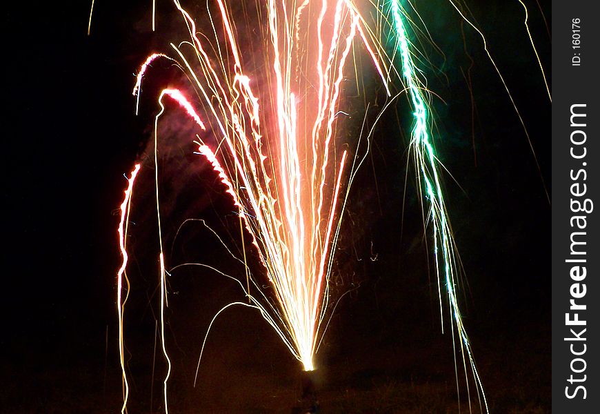 Multi-color fireworks shot in a backyard.