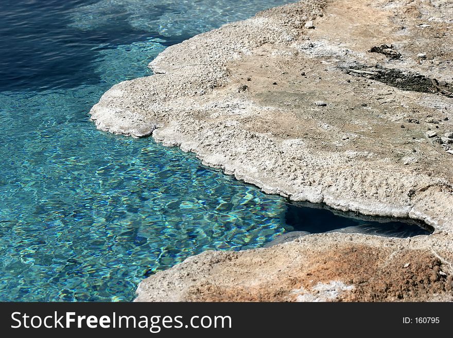 Beautifully clear and turquoise water at a mineral pool in yellowstone national park. Beautifully clear and turquoise water at a mineral pool in yellowstone national park