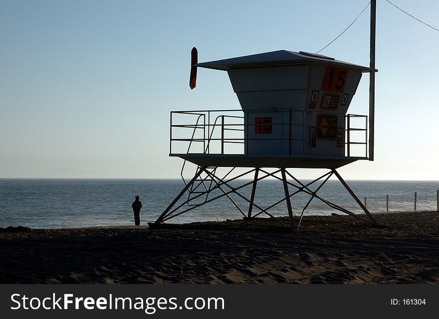Silhouette of a lifeguard house and person. Silhouette of a lifeguard house and person