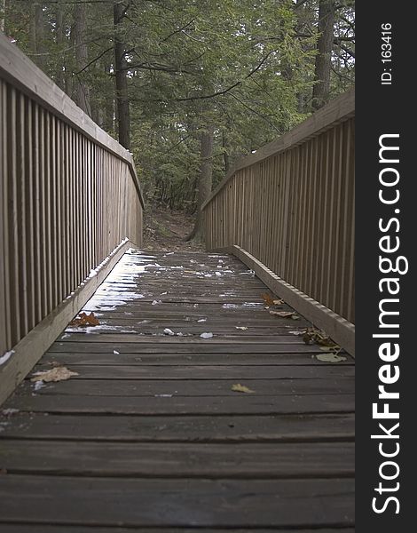 Wooden bridge with light snow cover