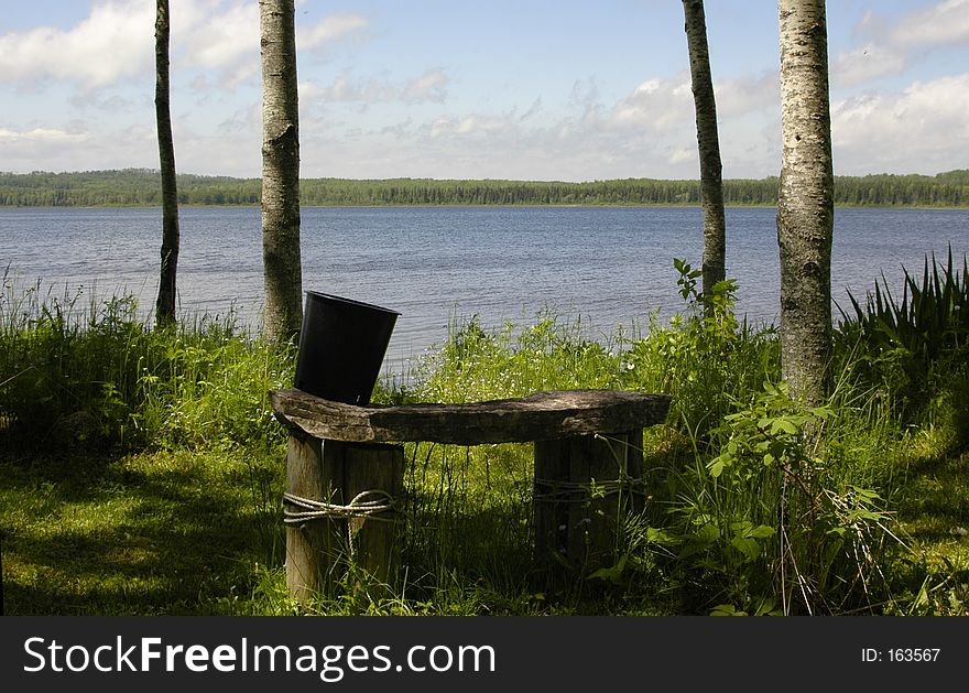 Quiet bench along a peaceful shoreline. Quiet bench along a peaceful shoreline