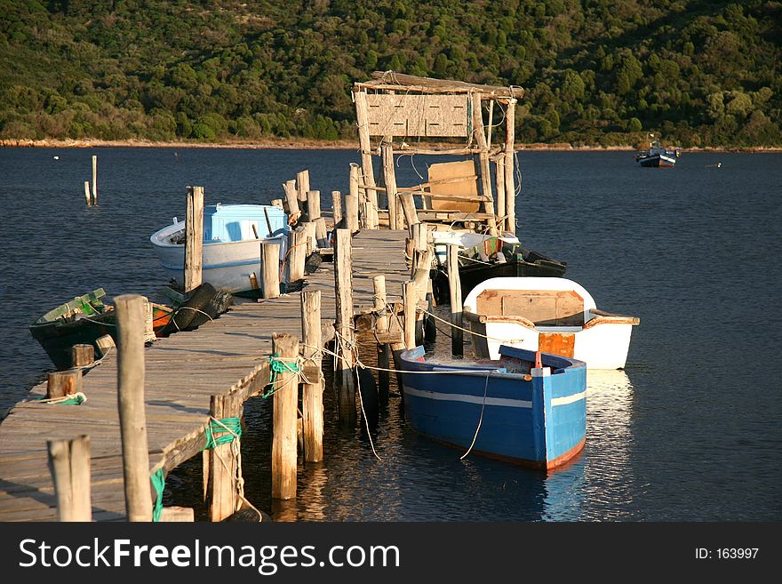 Twisted landing stage with colored boats