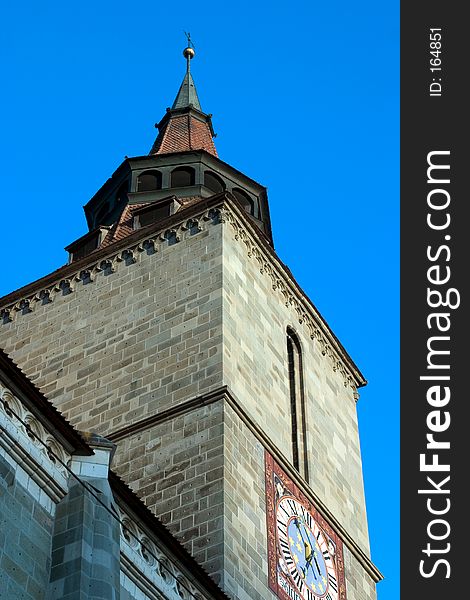 Church clock tower on blue sky