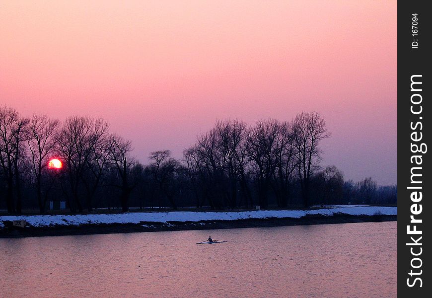 Man rowing at cold evening. Man rowing at cold evening.