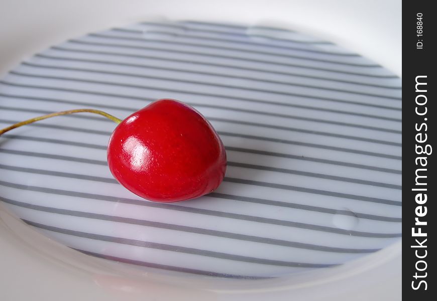 Isolated cherry on a plate. Isolated cherry on a plate