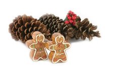 Gingerbread Men And Pine Cones (focus On Gingerbread Men) Stock Images