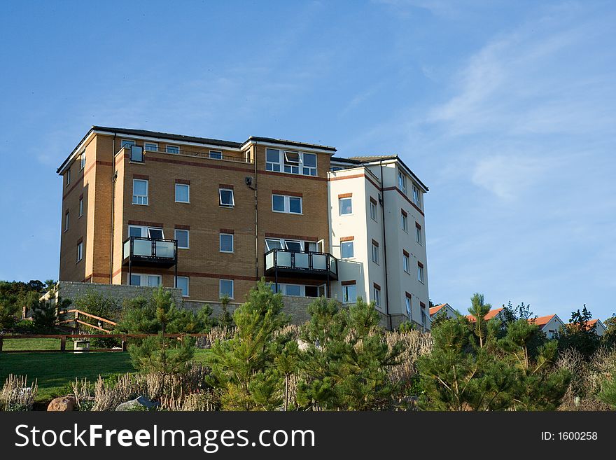 New block of flats situated on top of a hill looking out. New block of flats situated on top of a hill looking out