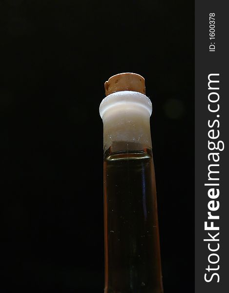 Glass bottle with bung on black background