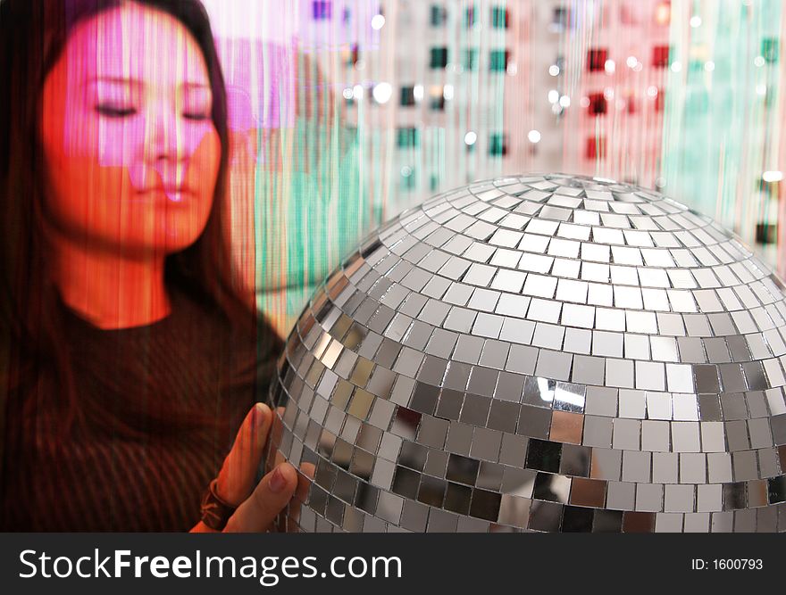 Studio shot of japanese woman holding glitterball. Studio shot of japanese woman holding glitterball