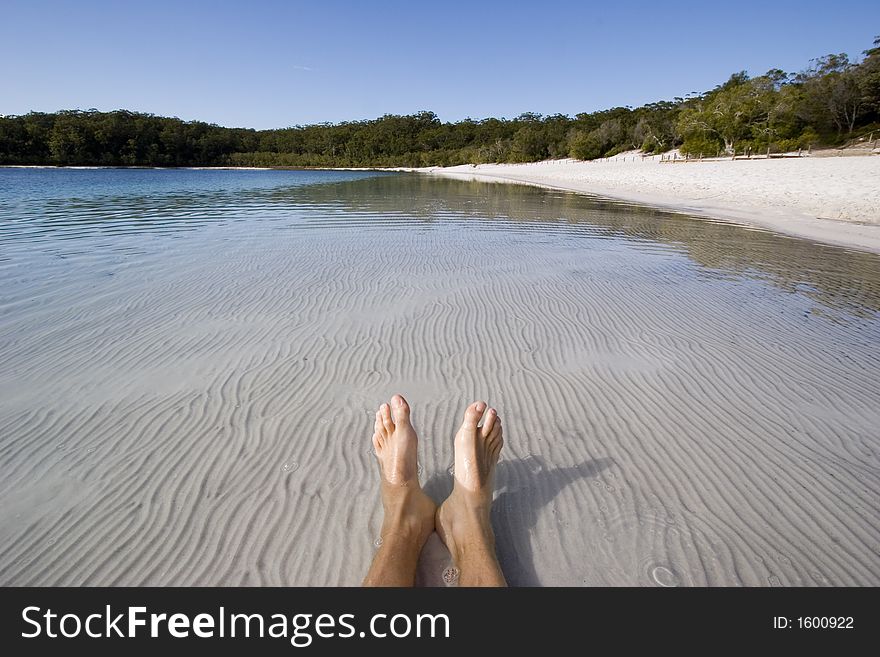 Mans feet and legs lying in lake mckenzie. Mans feet and legs lying in lake mckenzie