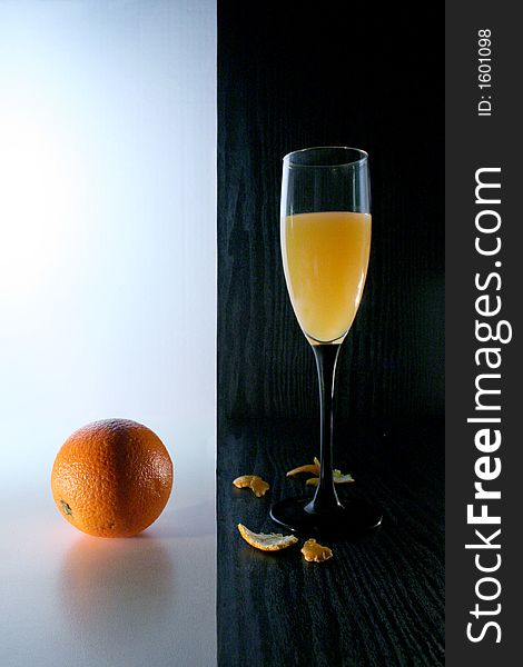 Orange juice and orange on white and black background. Orange juice and orange on white and black background