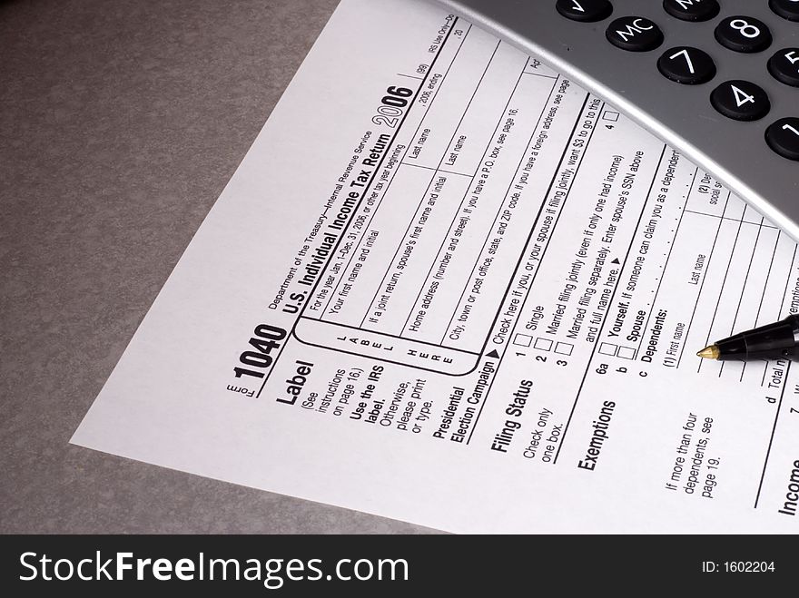 Tax form, pen and calculator with wide DOF. Tax form, pen and calculator with wide DOF