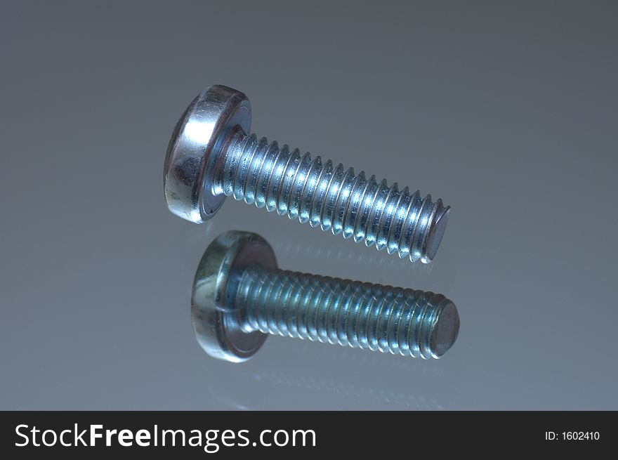 Screw on a reflecting surface close shot. Screw on a reflecting surface close shot