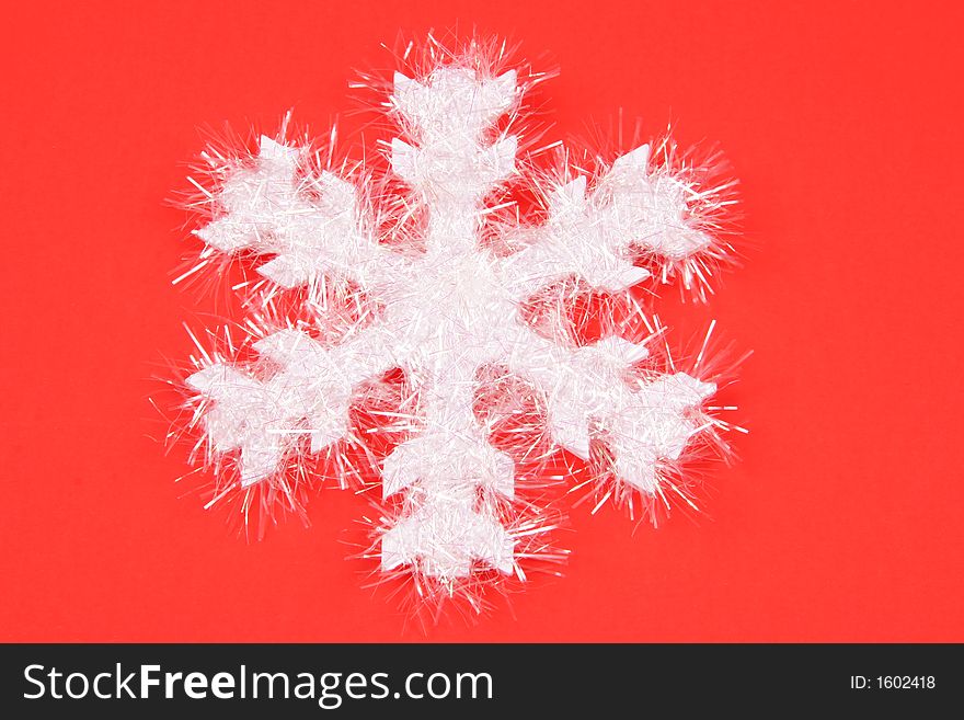 White Snowflake On Red Background