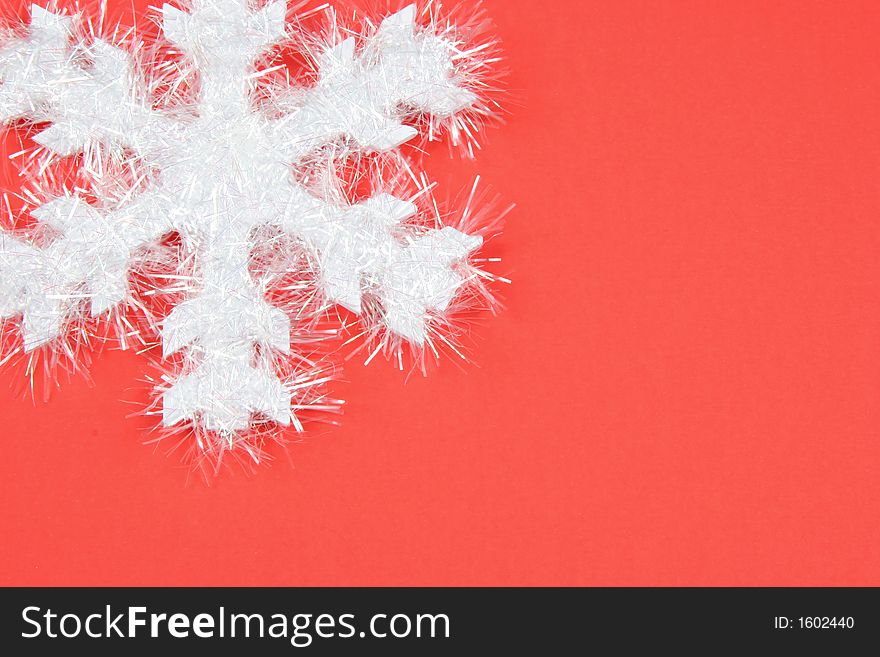 White snowflake on red background - top left corner