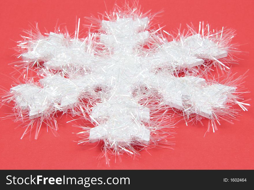 White snowflake taken closeup on red background. White snowflake taken closeup on red background