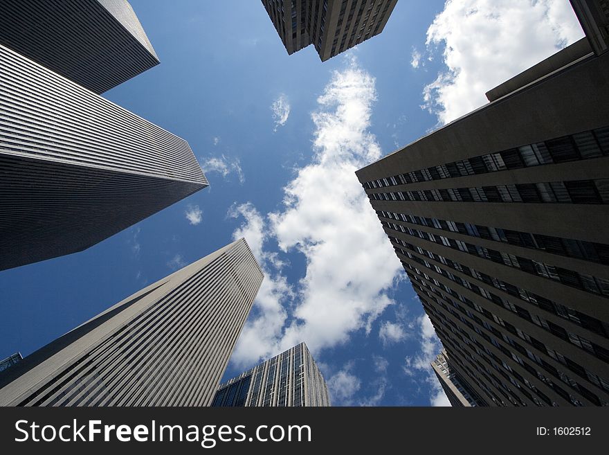 Modern skyscrapers against a bright blue sky