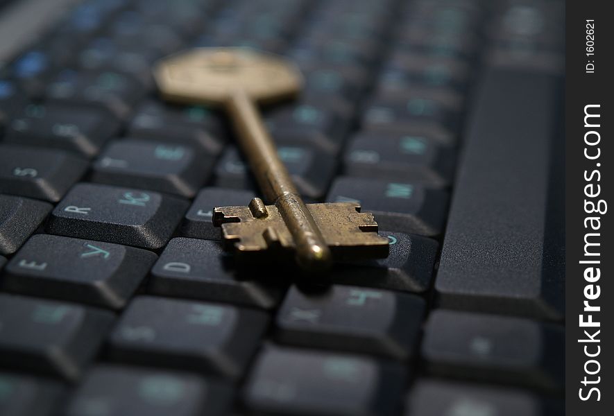 Vintage golden key on notebook computer keyboard. Vintage golden key on notebook computer keyboard