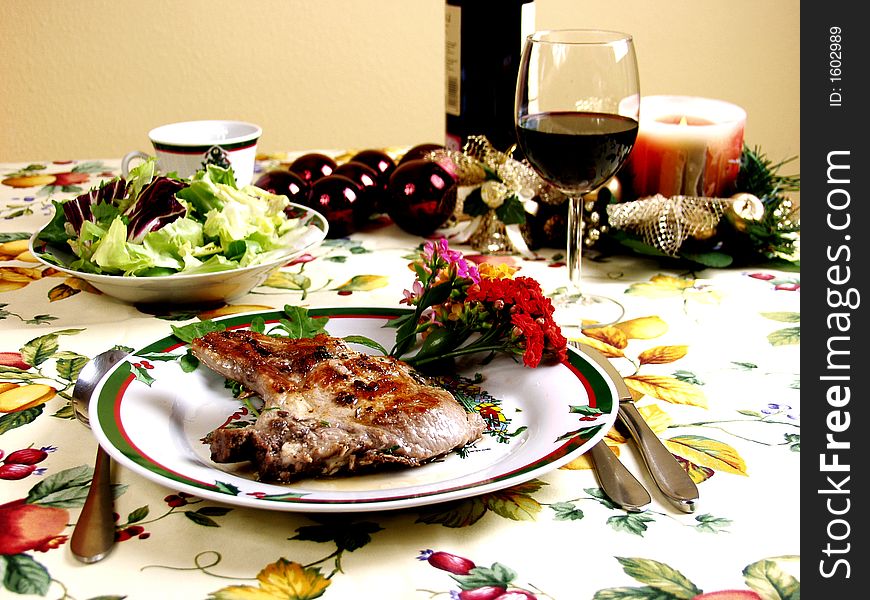 Decorated table for christmas dinner with pork steak grilled