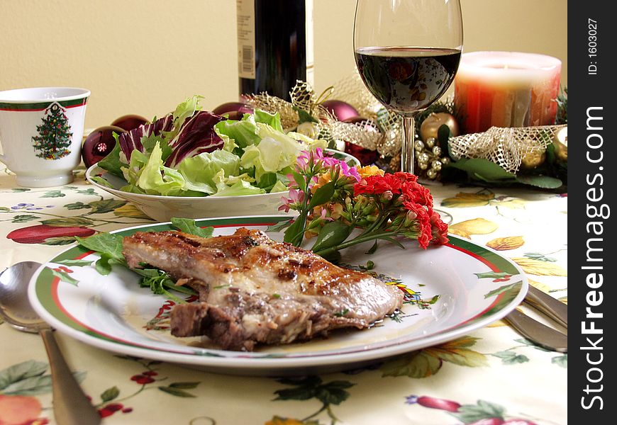 Decorated table for christmas dinner with pork steak grilled