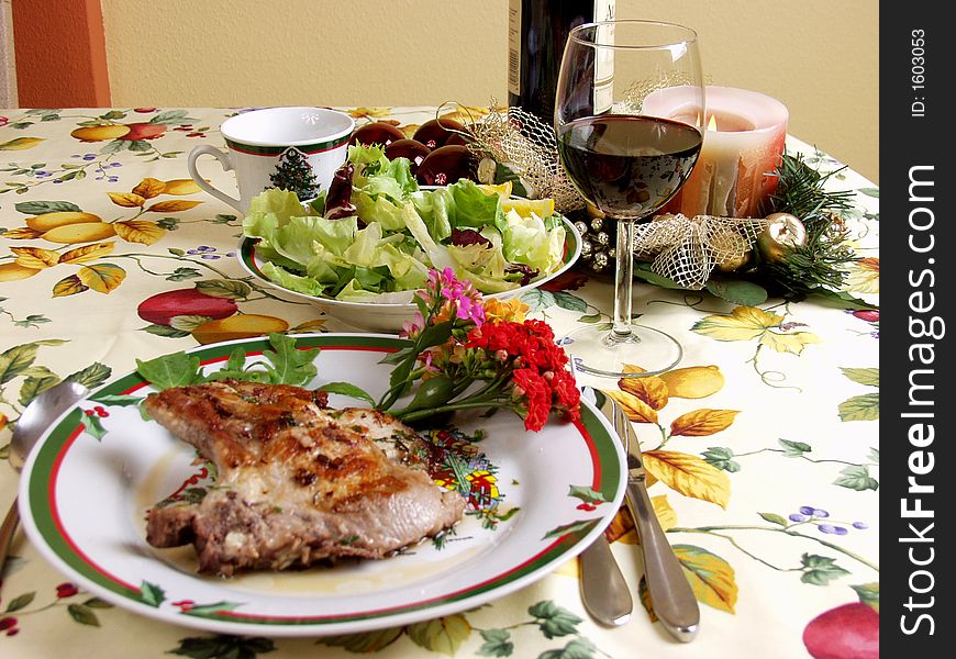 Decoration plater with pork steak, salad and red wine cup