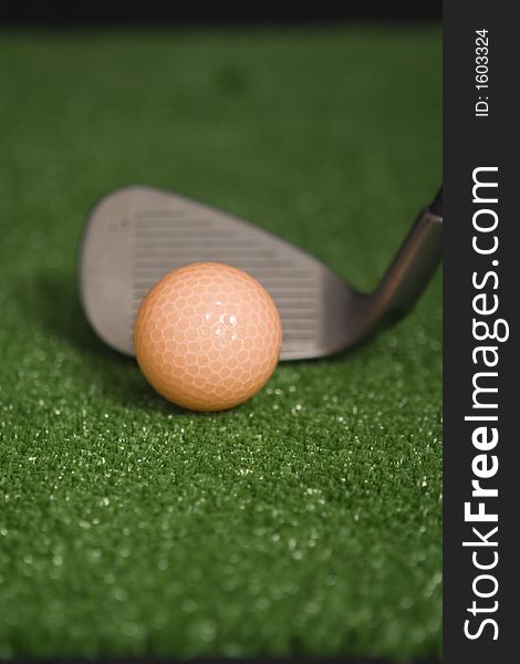 Picture Of Orange Golf Ball And Iron At Address