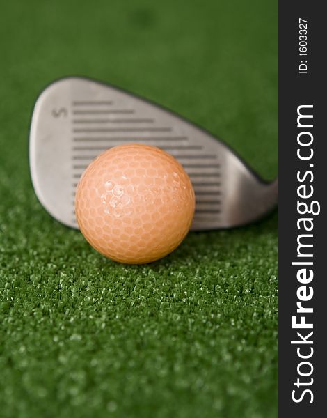 Picture Of Orange Golf Ball And Sand Wedge At Address