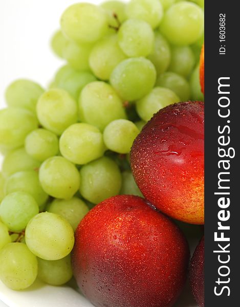 Colorful nectarines (peaches) and green grapes. Closeup. Colorful nectarines (peaches) and green grapes. Closeup.