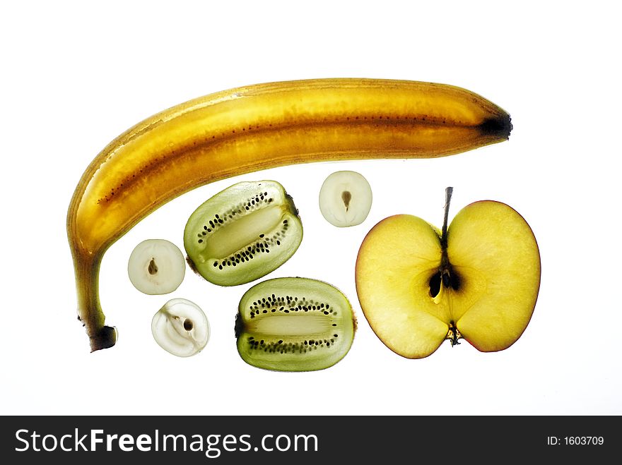 Picture of slice of various fruits - kiwi, banana, apple and grapes.