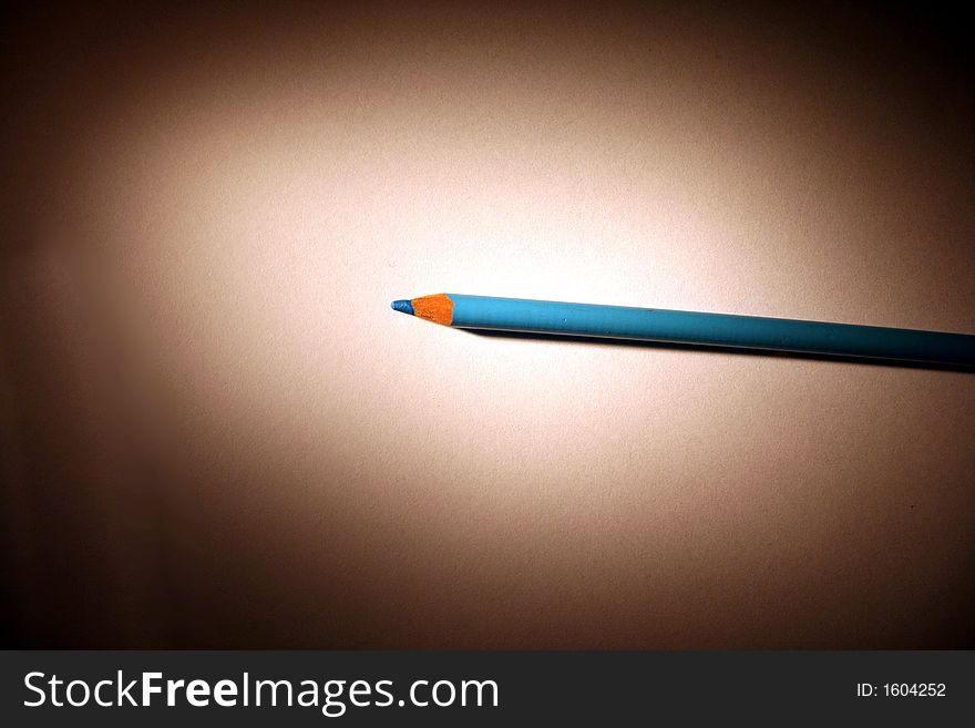 Blue colored pencil in a spotlight. Blue colored pencil in a spotlight.