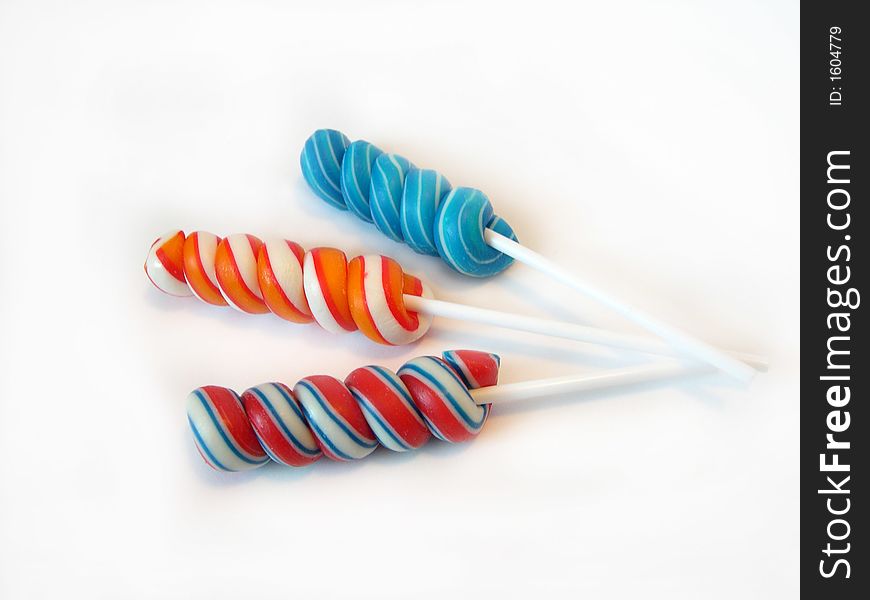 Multi-coloured a sugar candy on a stick on a white background