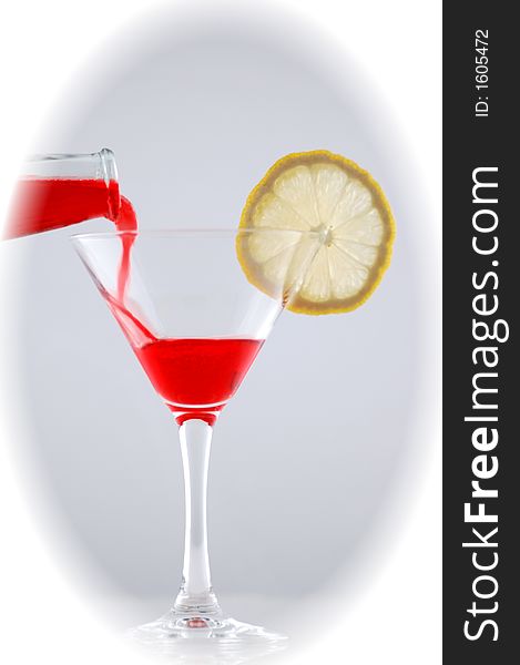 Red soft drink with lemon and ice