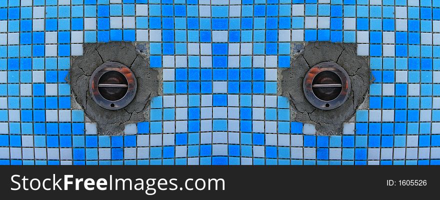 Cororful ceramic white and blue tiles between drainage holes. Cororful ceramic white and blue tiles between drainage holes
