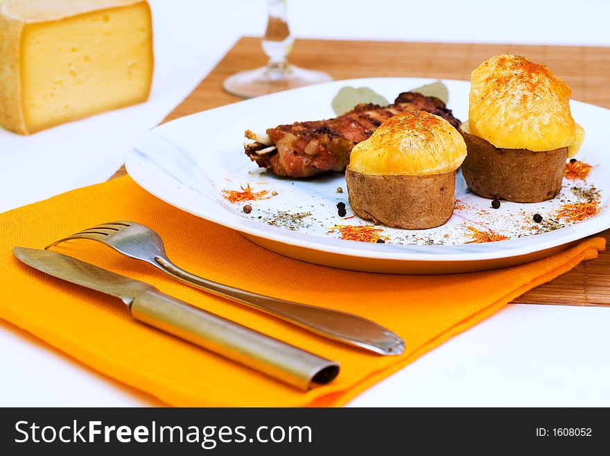 Baked Pork ribs and potato baked with cheese. Baked Pork ribs and potato baked with cheese