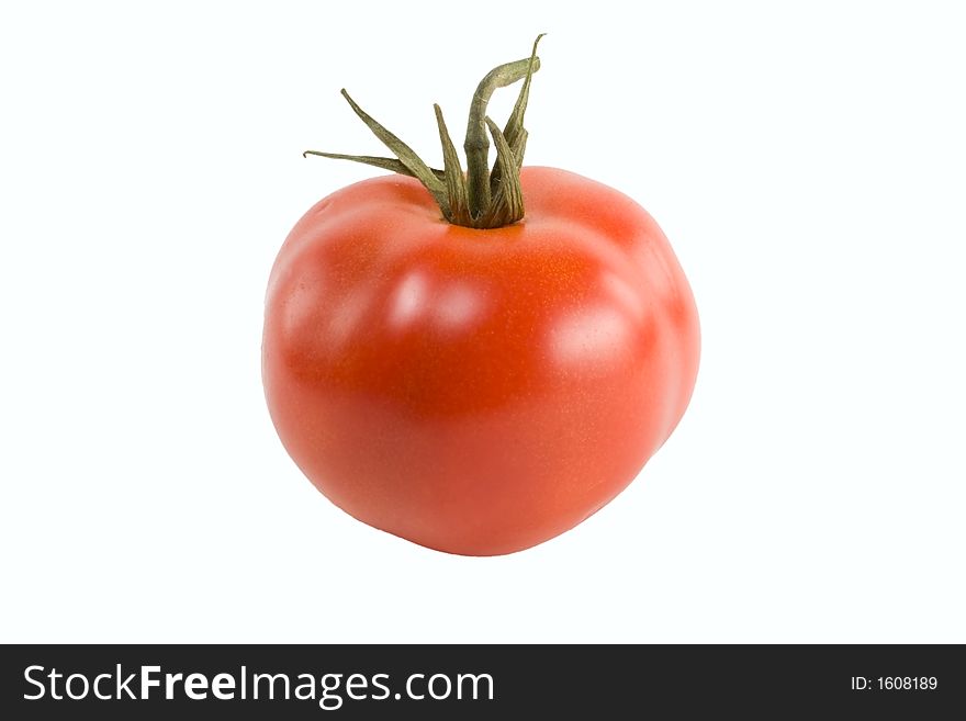 A ripe red tomato isolated over white. A ripe red tomato isolated over white