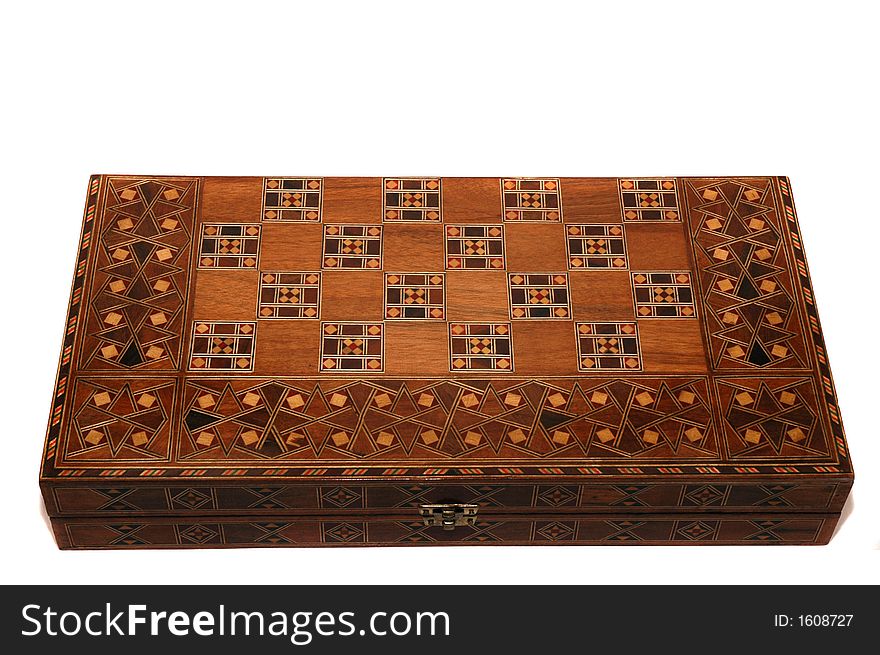 Handcrafted wooden backgammon board game on a white background