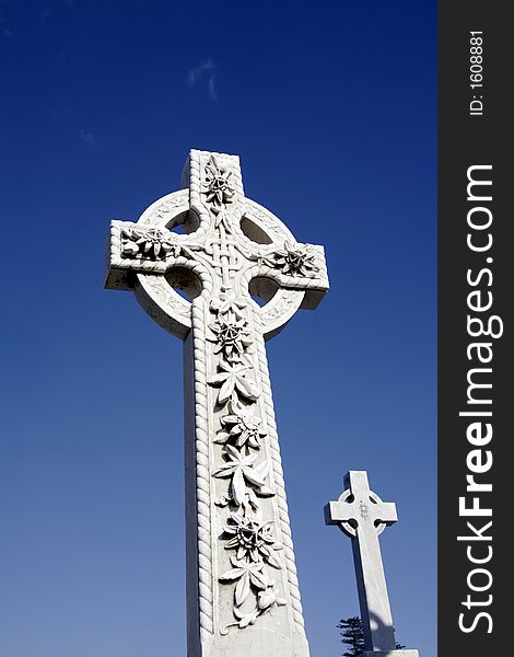 White Grave Stone Cross In Front Of Clear Blue Sky