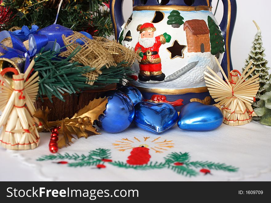 Christmas decoration with blue candle, hearts and oil lamp with santa. Christmas decoration with blue candle, hearts and oil lamp with santa