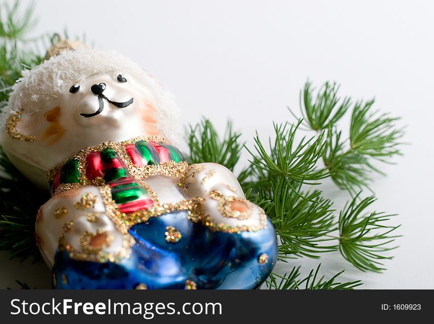 Shiny christmas decorative bear and evergreen branch. Isolated, white background, copy-space. Shiny christmas decorative bear and evergreen branch. Isolated, white background, copy-space
