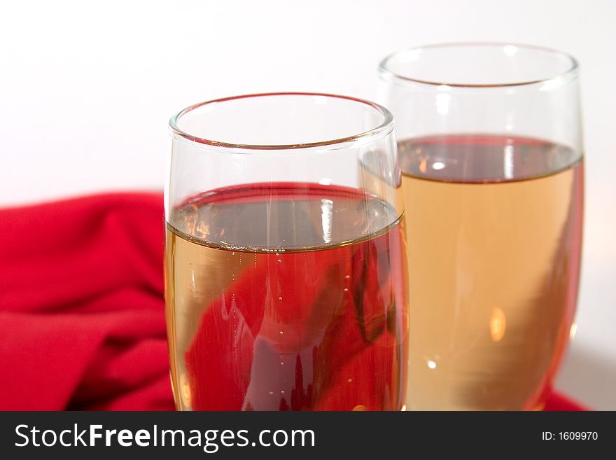 Close-up of two glasses of white  wine or champagne on white background. Close-up of two glasses of white  wine or champagne on white background