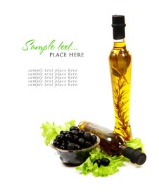 A Bottle Of Olive Oil With Herbs And Black Olives Stock Image